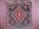  Silk wefted Qashqai bagface, circa 1900. Typical over-dyed 'hot' red. Emerald green field, approx 2' x 2'