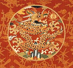 Ming Dragon Roundel on a pane1 of silk velvet with gold embroidery.