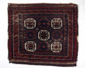  Old Baluch bagface with an unusual allover octagon design. Overall very low pile with extensive brown oxidation. Some original selvages and remnant end flat weave. No tears, no holes, no repairs. All natural colors. Selling \
