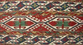Mafrash side panel, Qarabagh region, generous use of undyed cotton in the extra weft wrapping, ivory warps with wool foundation wefts; the motif of the centre field is similar to: Wertime, Sumak Bags, pl. 112; no repairs; 92 x 35 cms