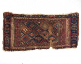  Old Jaf Kurd bagface fragment with some interesting design features but in very very rough condition. Pile varies from some good medium length to very low pile to none at all with large areas of foundation exposed. Heavy brown oxidation. Edges all rough with loss, gouges. All good natural colors. Perimeter of back has old adhesive. Appears to have an area of old staining. Selling \