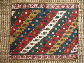 Mafrash end panel, Southern Caucasus, Qarabagh region, 44 x 37cms, wool warps, some silk foundation wefts, cotton extra-weft wrapping in borders and in one diagonal stripe; same design as one of the kustar anchor pieces (Wertime, Sumak Bags, p. 173).