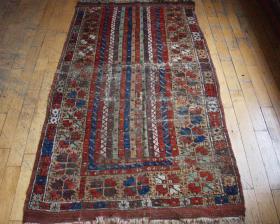  Old Turkish long rug fragment with an interesting striped design and a classic old border. In rough condition with creases, tears, small holes and old moth nibbles. Still a fair amount of good pile. Original selvages, and one flat woven end. Other end cut and old kilim sewn on. All good natural colors including some nice aubergine, strong reds, good old greens, and a very pretty apricot. In \