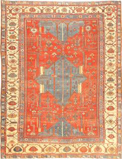 Antique Perisan Serapi / Bakshaish Carpet, late nineteenth century - 
11 x 14.6
A pattern of monumental star-shaped medallions in soft blue repeats majestically up the center of this incomparably beautiful antique Bakshaish. The central medallion appears in its entirety, while the upper and lower ones are halved. The warm red field is filled with an impressive array of abstract hooked forms and stylized flowers and shrubs. The stylized arabesque border set against an ivory ground is no less impressive than the field in terms of the bold precision of its drawing and its adroit use of color. Bakshaish carpets are exceptional as a group generally, but even among its own kind, this carpet is virtually without peer.