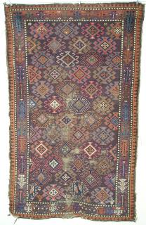  Baluch rug on a chocolate-purple ground with a rich and diverse color palette (including a forest green, several blues, pink, orange and purple) and an elegant simple border with geometricized flowering plants. symmetrically knotted. 84x132 cm(33''x52'' inches)<p>I'll be in the San Francisco Bay area all summer. If you are in town and would like to see some rugs (some for sale and some not) please email me.