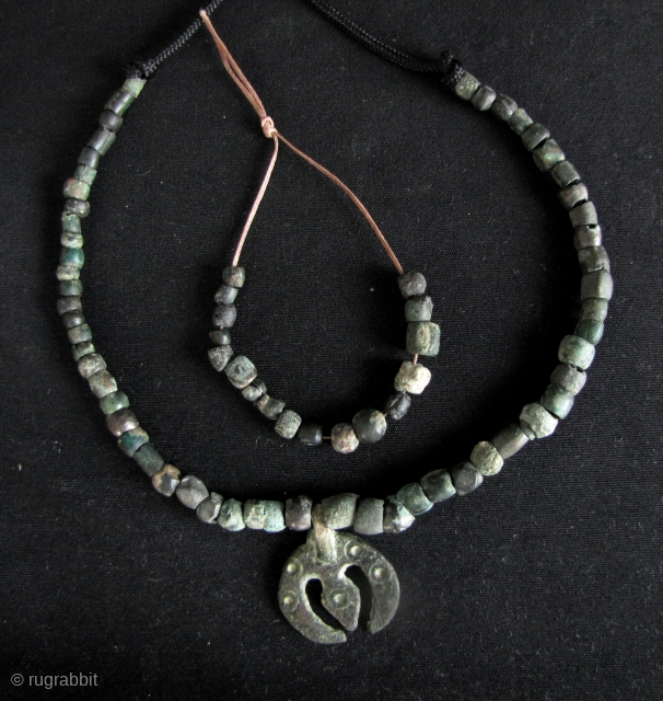 Ancient Shavaite Trishula: Quirky strands of bronze beads and Kushan charm in the shape of a Hindu Trishula (trident). I acquired these with a group of Kanishka coins that were found in  ...