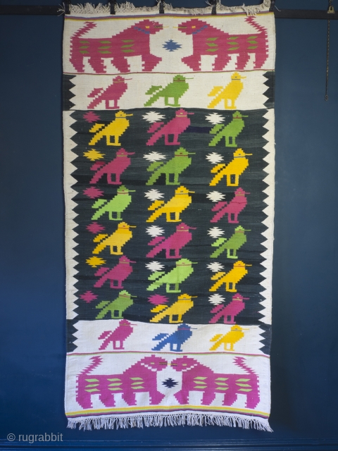 Mid Century Dhurrie rug, 203cm x 104cm (80 inches x 41 inches)

A cheerful and very charming rug from Rajasthan, circa 1950. The central field with rows of brightly woven birds drawn, in  ...
