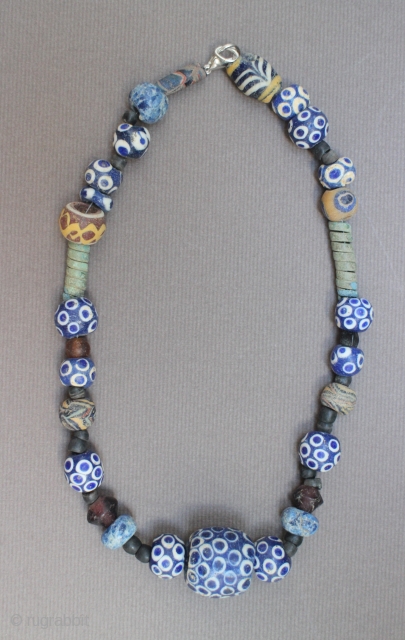 An ancient glass, stone and metal necklace, 2nd-1st centuries B.C., Middle East, restrung with modern clasp, 41cm long               