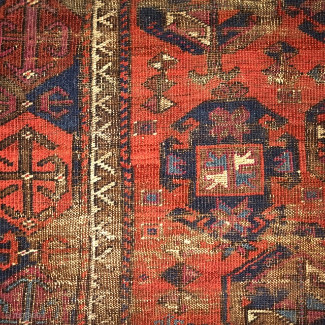 Worn and whipped rare red-ground Timuri type Baluch rug with a Saryk border. Madder red ground with cochineal highlights. Squarish shape.            