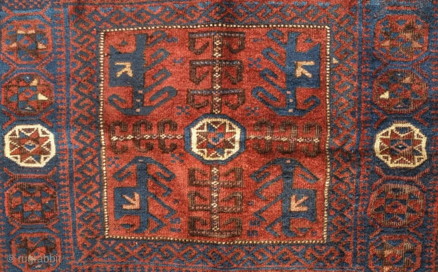 Timuri Baluch saddle bag face, 19th century.  Four abstracted dragons or mythical creatures in the corners of the central field. Eight-pointed stars symmetrically arranged around the inner border.  80 x  ...