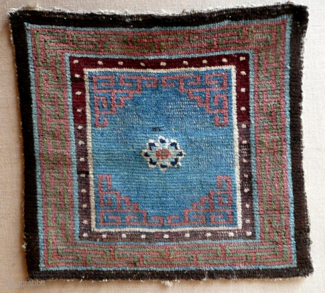 Tibetan meditation mat with single lotus flower on a fantastic sky blue background, rare, first half 19th C.               