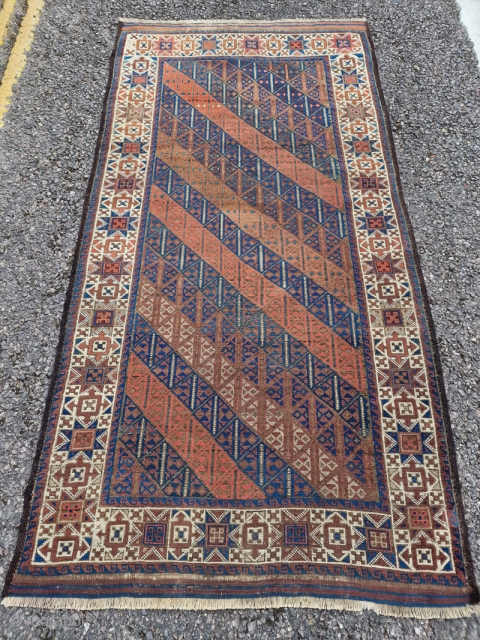 Symmetrically knotted Baluch / Balouch / Beluch rug with an unusual "tobacco" star border and a great field. In natural light you can see subtle abrash in the deep blues/greens and reds  ...