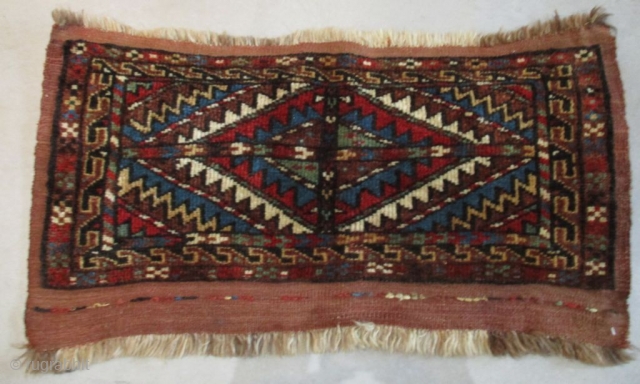 This late 19th early 20th century antique Turkomen rug #8096 probably Yomud or Afghan measures 1’4” X 2’4”. It has a single medallion in the center of the rug in red, ivory,  ...