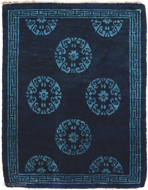 An elegant but subtle two-toned naturally dyed Tibetan seating carpet. A simple turquoise coloured ‘T’ border encases an uncomplicated dark blue central field set with turquoise rosettes, or roundels. It has good  ...