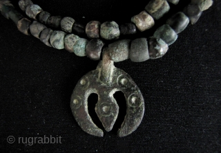 Ancient Shavaite Trishula: Quirky strands of bronze beads and Kushan charm in the shape of a Hindu Trishula (trident). I acquired these with a group of Kanishka coins that were found in  ...