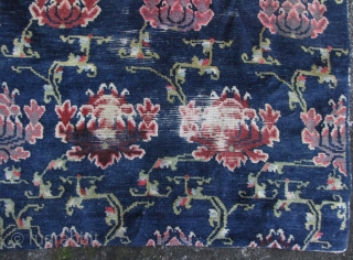 Unusually long Tibetan rug (almost a runner), cotton warp, wool weft with side view of lotus scrolling pattern, circa late 19th to early 20th century. Pile missing (please see enlargements), but no  ...