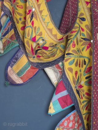 Rare and very large festival toran/tent banner, 450cm x 42cm (177 x 16.5 inches). Hand embroidered in vibrant pinks and greens on a beautiful Saffron ground. Gujurat, circa 1940.

The pennants, stitched together  ...