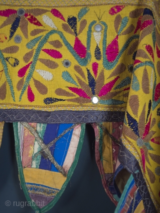 Rare and very large festival toran/tent banner, 450cm x 42cm (177 x 16.5 inches). Hand embroidered in vibrant pinks and greens on a beautiful Saffron ground. Gujurat, circa 1940.

The pennants, stitched together  ...