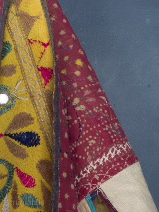 Rare and very large festival toran/tent banner, 450cm x 42cm (177 x 16.5 inches). Hand embroidered in vibrant pinks and greens on a beautiful Saffron ground. Gujurat, circa 1940.

The pennants, stitched together  ...