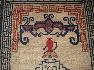 Unusual small Chinese rug with auspicious bats and flower pots. Uncommon use of madder red and un-dyed brown wool pile. cotton foundation. Perhaps Ningxia but seems a bit aberrant.  Perhaps Gansu  ...