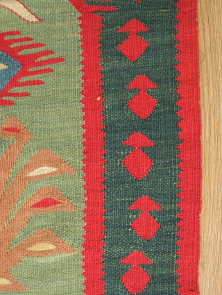 Sarkoy kilim, 19th century.  Nine niches with bird-headed trees of life topped with an evil eye or sun motif on a green ground.  In general very good condition. 108 x  ...
