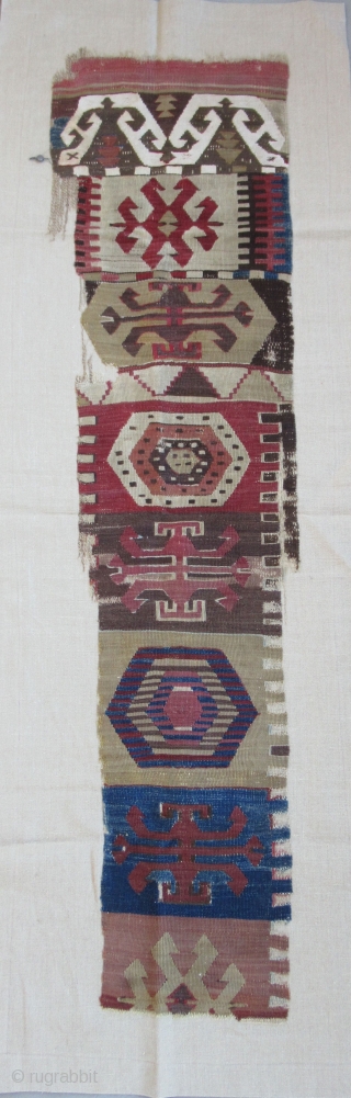 Anatolian kilim border fragment....Southeast Anatolia ( Reyhanli ? Kurdish ?) before 1825....wool w/ cotton-ground end-panel...very fine weave....frag. size 1'4" x 5"( 40 x 155 cm) ....unusual archaic motif drawings...professionally mounted on linen....condition  ...
