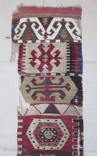 Anatolian kilim border fragment....Southeast Anatolia ( Reyhanli ? Kurdish ?) before 1825....wool w/ cotton-ground end-panel...very fine weave....frag. size 1'4" x 5"( 40 x 155 cm) ....unusual archaic motif drawings...professionally mounted on linen....condition  ...
