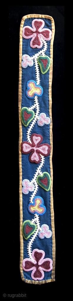 19th century Great Lakes bandolier bag strap.  Possibly Ojibwe tribe. Nine different colors of seed beads decorate this strap. The beads are sewn to a dark blue woolen trade cloth background  ...