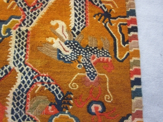 Tibetan khaden, mid-20thC,34 by 64 inches, dramatic tiger (What was the weaver smoking?)flying through an orange/brown sky filled with cloudbands and flaming pearlsd          