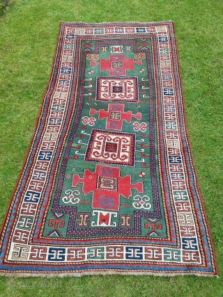Good old Karachop Kazak with a beautiful green field.
Some repair and a little wonky.
244cm x 135cm (8’ x 4’5)              