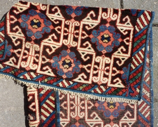 Lovely and unusual antique Kuba(?)Caucasian small poshti (?) rug, 95x62 cm.,ca. 1900, with multiple kufic border elements used as field design. Woven on woolen warps with brown woolen wefts. It has a  ...
