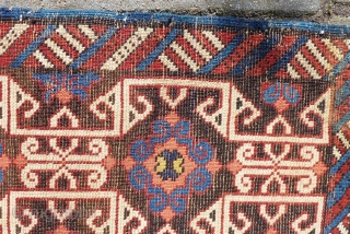 Lovely and unusual antique Kuba(?)Caucasian small poshti (?) rug, 95x62 cm.,ca. 1900, with multiple kufic border elements used as field design. Woven on woolen warps with brown woolen wefts. It has a  ...