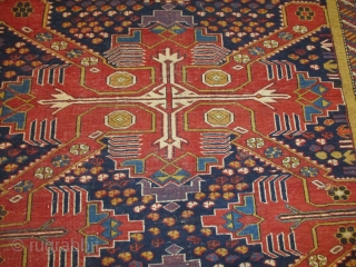 This circa 1880 Shirvan/Kuba measures 4’7” X 6’4”. It has three tomato red Saint Andrews crosses on an indigo ground. The ground is covered in quartered octagons in ivory, tobacco, two shades  ...