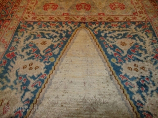 This 19th century Angora Oushak Oriental Rug measures 6’7” X 11’6”. The prayer design is in ivory containing two columns in rust with a bulbous design at either end of the columns.  ...