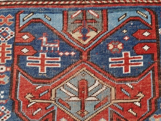 Antique Kazak rug, 108 x 196 cm. late 19 th. century. Unusual stylised wing design. Dark brown colour corroded and slightly reduced at both ends.        