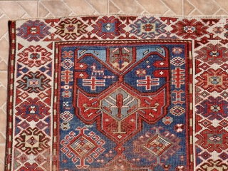 Antique Kazak rug, 108 x 196 cm. late 19 th. century. Unusual stylised wing design. Dark brown colour corroded and slightly reduced at both ends.        