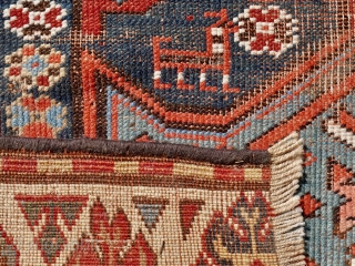 Antique Kazak rug, 108 x 196 cm. late 19 th. century. Unusual stylised wing design. Dark brown colour corroded and slightly reduced at both ends.        