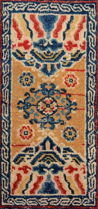 Above-saddle carpet woven in the Ningxia region of China in the early 1900’s. The main border consist of interlinked swastikas, while the inner border features a single key meander. At either end  ...