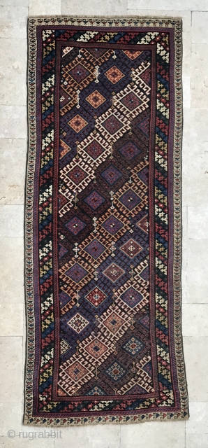 Description and origin: attractive Caucasian carpet with repetitive geometric designs. Interesting main border and rich combination of colours.

Age: around 1950.

Dimensions: 246 cm X 96 cm.

Condition: very good condition. Full pile. Very limited  ...