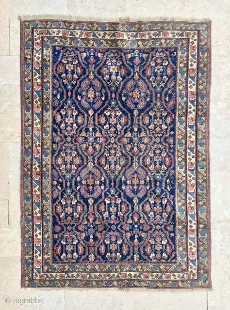 Description and origin: Caucasian carpet with an original geometric border and a main field composed or repetitive floral design.

Age: anterior to 1950.

Dimensions: 187 cm X 132 cm.

Condition: overall good condition. Low pile.  ...