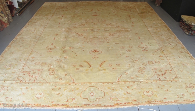 Very pale antique Borlu carpet with Angora wool, 4.54m x 3.50m. Some old repairs, but still very decorative.               