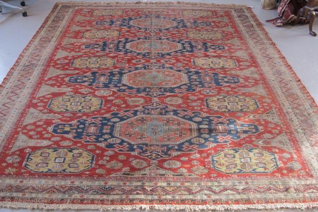 Soumac carpet 2.75m x 2.32m (9' x 7' 8") circa 1880. Superb colour range, with unusual quadruple medallion format. Heavy corrosion of the browns but in honest 'estate' condition. Most of the  ...