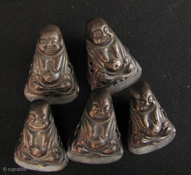 Happy Buddhas: Set of Qing Dynasty silver repoussé Chinese child’s hat ornaments. Very sweet little collection of 5 Budai and a lions face. Budai H: 2.9cm/1.1in and W: 2cm/0.8in and lion face  ...