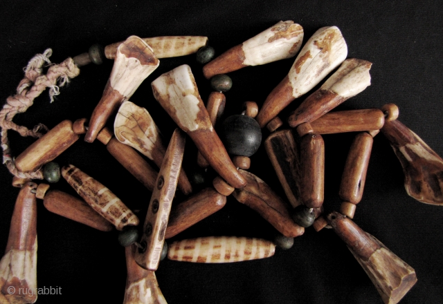 Chin Animal Bone Necklace: Eclectic strand of spherical wood, cylindrical bone and buffalo tooth beads, from the Chin ethnic group in Myanmar. Some of the bone beads have been dyed to resemble  ...