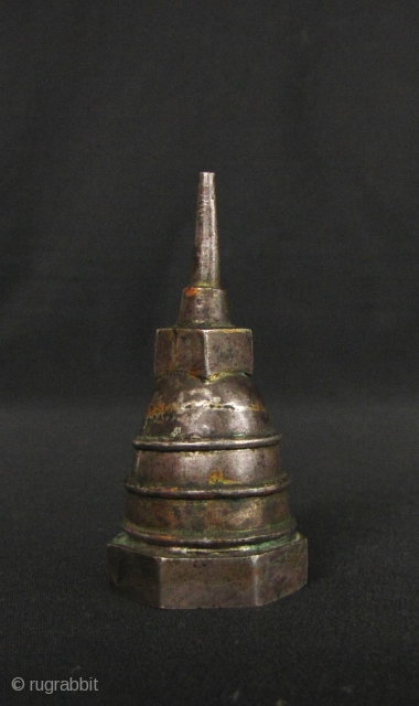 Silver plated copper reliquary box in the shape of a Sinhalese chedi (stupa) with hexagonal base, Kandy period Sri Lanka. This would have kept a tiny amount of ash or bone from  ...