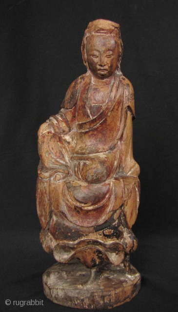 Qing Dynasty Guanyin: Lovely, circa 18th century wood statue of the Chinese Goddess of Mercy seated on a lotus leaf and buds.  There is one stem broken on the left bud  ...