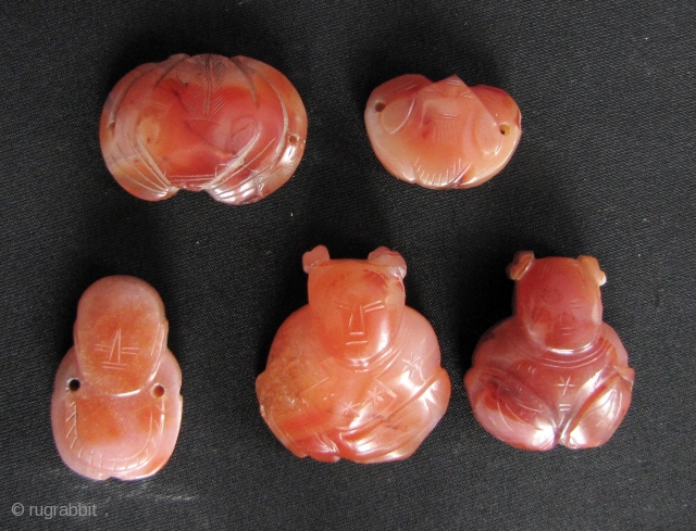 Five Qing Dynasty red agate/carnelian pieces carved into babies and bats- beautiful natural stone and classic Qing carving. These were originally meant to be sewn onto clothing or a hat. A few  ...
