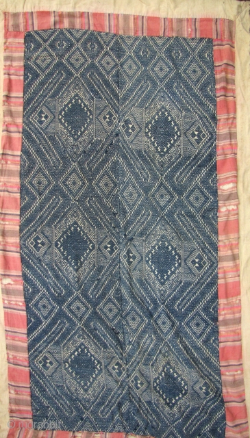 Nice old Laotian blanket from the Tai Dam ethnic group. The embroidered face and backing is made from all hand spun and hand woven thread. The border is frayed but the center  ...