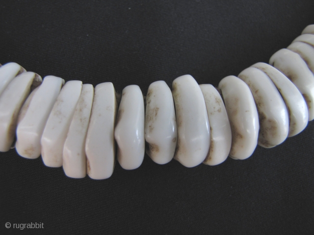 Antique Naga Beads:Antique: Fine and rare Naga child’s cowrie shell necklace from northwest Burma on hand woven macramé cotton cord. These is an old set, circa 80 years with an excellent worn  ...