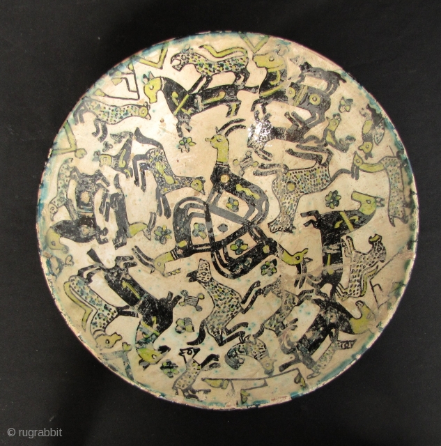 Nishapur Bowl: Large early Islamic Central Asian, Persian polychrome pottery bowl decorated with lively composition of animals - Circa 9/10th CE. Large repair (noted in last enlargements) and typical fritting. The red  ...